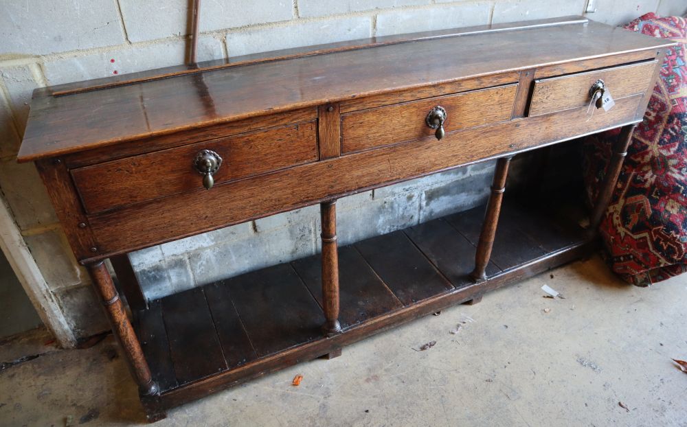 A Georgian oak three-drawer dresser base with potshelf, width 172cm